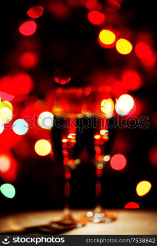 Flutes of champagne bokeh lights New year celebration concept. Flutes of champagne bokeh lights