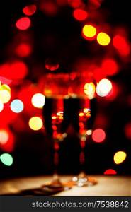 Flutes of champagne bokeh lights New year celebration concept. Flutes of champagne bokeh lights