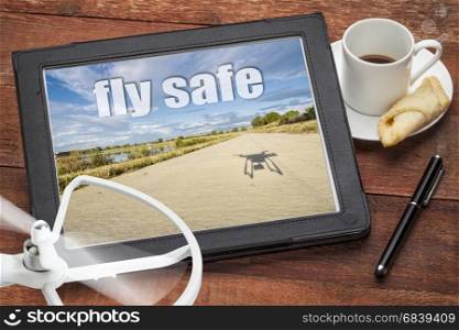 fly safe concept or reminder - aerial picture on a digital tablet with a drone propeller and coffee