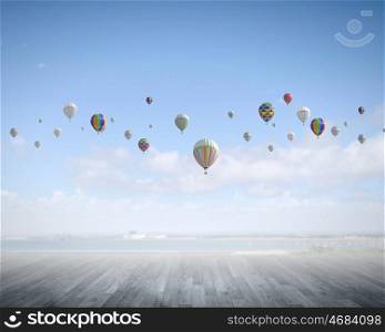 Flying aerostats. Colorful balloons flying high in blue sky