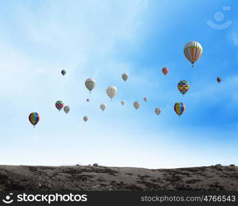 Flying aerostats. Colorful balloons flying high in blue sky