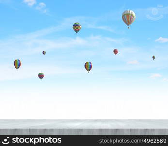 Flying aerostats. Colorful balloons flying high in blue sky
