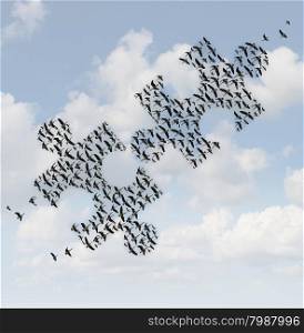 Flying birds puzzle as a business concept for group strategy as two flocks of geese shaped as jigsaw puzzle pieces comming together as a teamwork success metaphor.