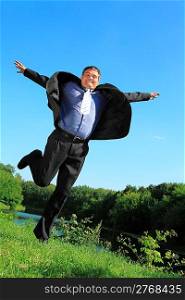 flying businessman outdoor in summer full body