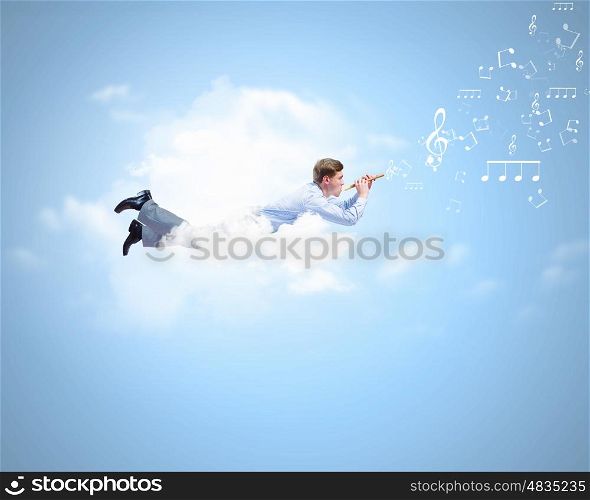 Flying businessman. Young man flying in sky and playing fife