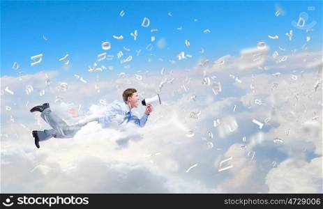 Flying businessman. Young man flying in sky and screaming in megaphone