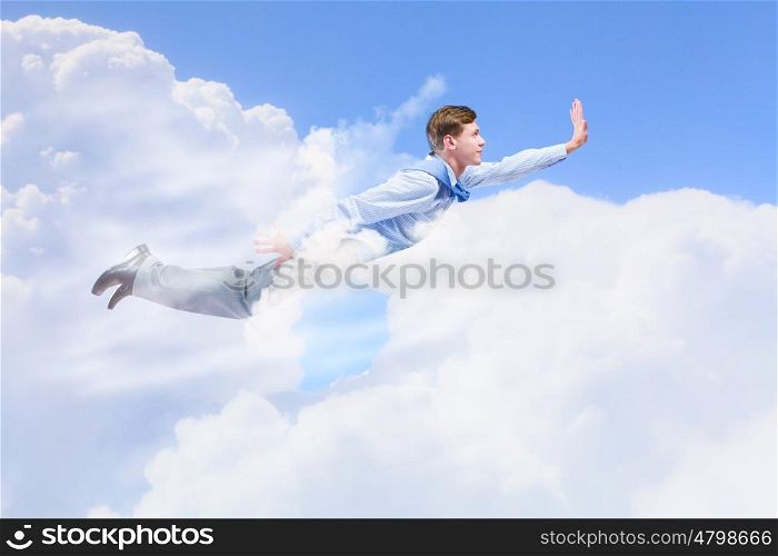Flying businessman. Young super businessman flying high in sky