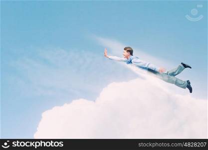 Flying businessman. Young super businessman flying high in sky