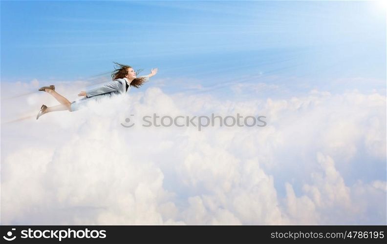 Flying businesswoman. Young determined businesswoman flying high in sky