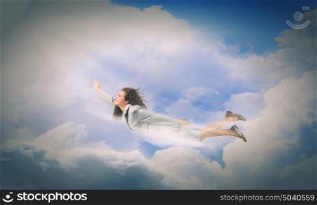 Flying businesswoman. Young determined businesswoman flying high in sky