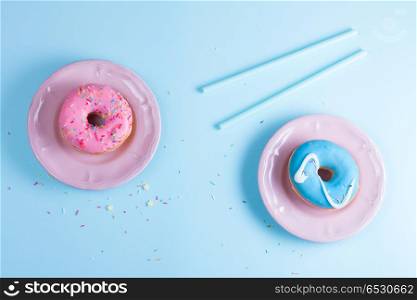 flying doughnuts on blue. Two sweet doughnuts on blue background with copy space