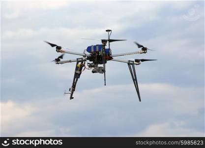 Flying drone in the sky with mounted digital camera. Flying drone in the sky with mounted digital camera.