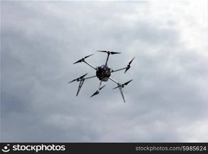 Flying drone in the sky with mounted digital camera. Flying drone in the sky with mounted digital camera.
