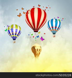 Flying elephant. Sunny image of elephant flying in sky on aerostat