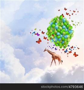 Flying giraffe. Sunny image of giraffe flying high in sky on aerostat