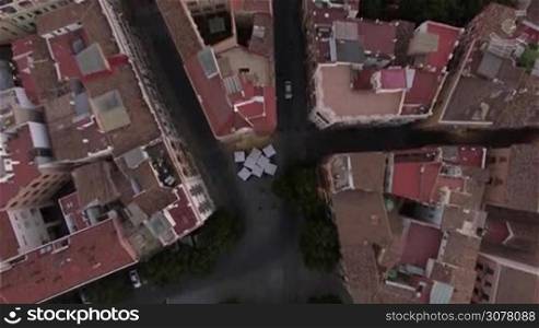 Flying over house roofs and Serranos Towers in Valencia, Spain. Ancient city gate in Valencian Gothic style built between 1392 and 1398