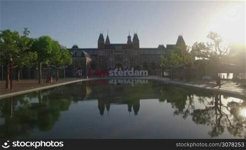 Flying over the pond in front of I amsterdam slogan and Rijksmuseum. Art Square, Amsterdam