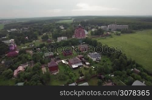 Flying over the private houses and Cathedral of Ascension in Lukino Village, Russia
