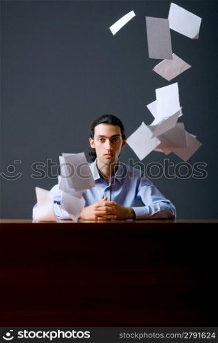 Flying paper and businessman in office