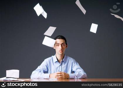 Flying paper and businessman in office