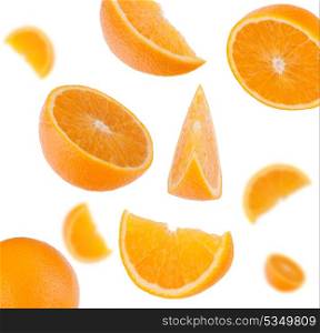 flying sliced orange fruit segments isolated on white background