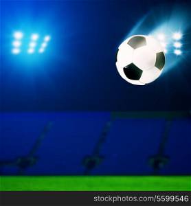 Flying soccer ball over green field, abstract sport backgrounds