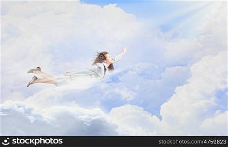 Flying superwoman. Young pretty businesswoman flying in blue sky