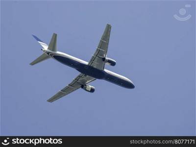 Flying white plane on blue sky background