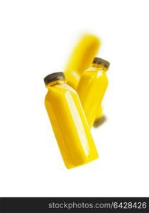 Flying yellow smoothie or juice bottle , isolated on white background. Branding copy space