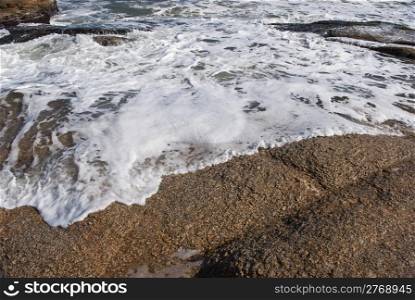 foam of sea on rocks
