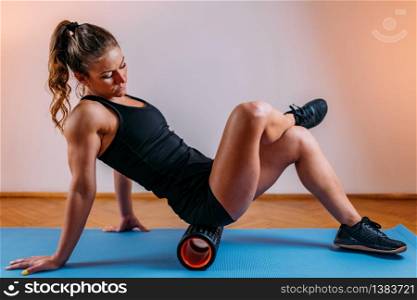 Foam Roller. Woman Using Foam Roller for Gluteus Muscle and Fascia Self Massage at Home . Foam Roller, Fascia and Muscle Massager for Self Massage at Home