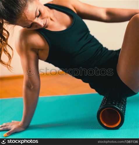 Foam Roller. Woman Using Foam Roller for Muscle and Fascia Massage . Foam Roller, Fascia and Muscle Massager