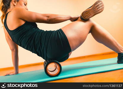 Foam Roller. Woman Using Foam Roller for Muscle and Fascia Massage . Foam Roller, Fascia and Muscle Massager