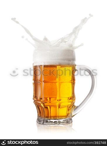 Foam splash in faceted beer mug isolated on white background. Foam splash in faceted beer mug