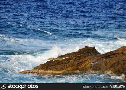 foam waves splash at stones on shore sea