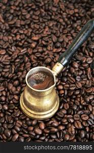 Foaming coffee in an arab copper coffee pot