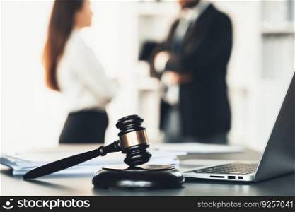 Focus closeup wooden gavel on blurred background of lawyer colleagues or legal team working at law firm office. Hammer of justice for righteous and equality judgment. Equilibrium. Focus closeup wooden gavel on blur background of legal team. Equilibrium