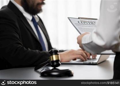 Focus contract paper on blur background of legal team or lawyer colleagues drafting legal documents in law firm office. Ethical and lawful resolution for clients disputes. Equilibrium. Focus contract paper on blur background of legal team. Equilibrium