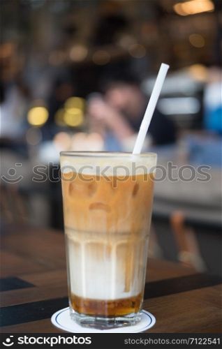 Focus of ice caramel macchiato in coffee shop area, selective focus.