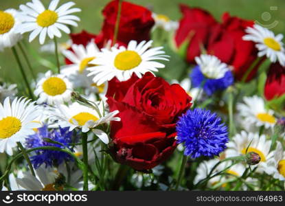Focus on a red rose in a bouquet with summerflowers
