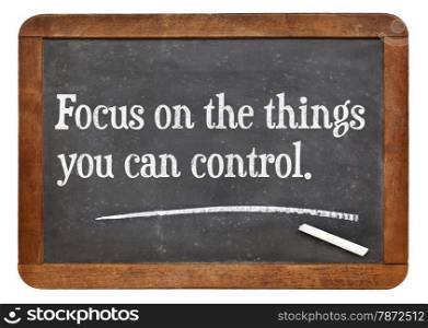 Focus on the things you can control - motivational advice on a vintage slate blackboard