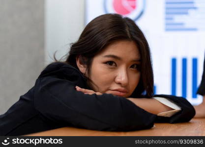 Focus portrait of female manger, businesswoman in the harmony meeting room with blurred of colleagues working together, analyzing financial paper report and dashboard data on screen in background.. Focus portrait of asian female manger with blurred background in harmony.