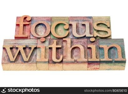 focus within word abstract - isolated text in letterpress wood type printing blocks stained by color inks