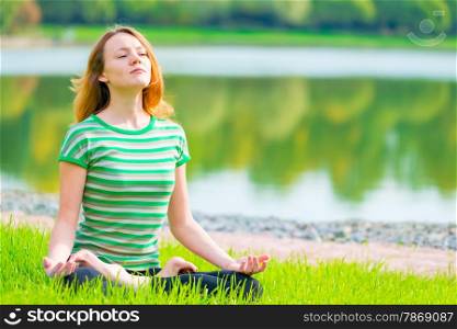 focused athlete relaxes in a lotus position on the nature