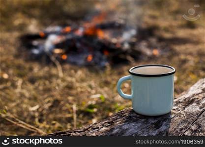 focused blue cup coffee burned out campfire. High resolution photo. focused blue cup coffee burned out campfire. High quality photo