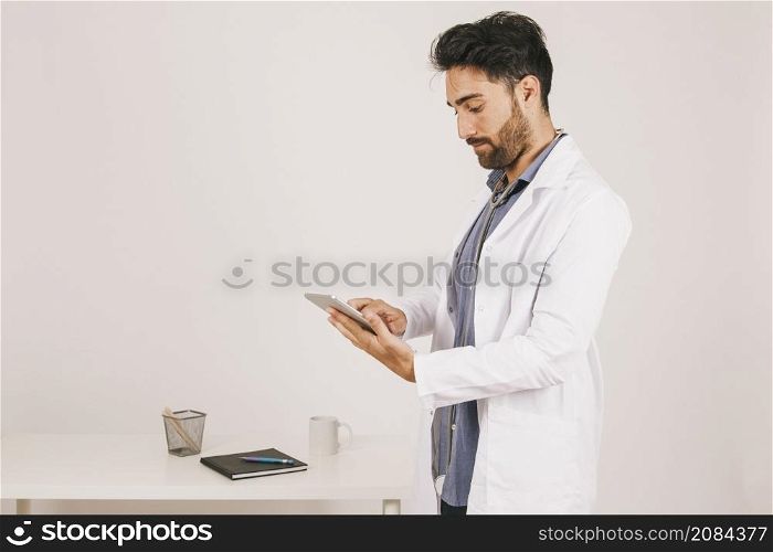 focused doctor working with ipad
