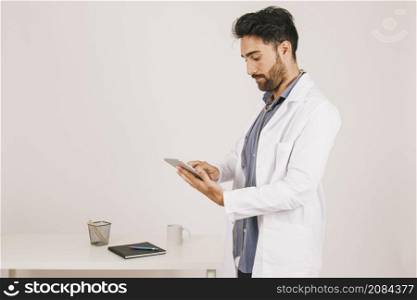 focused doctor working with ipad