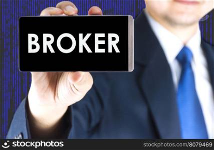 Focused of broker word on mobile phone screen in blurred young businessman hand and digital technology background