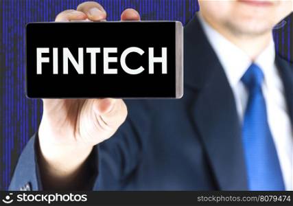 Focused of fintech word on mobile phone screen in blurred young businessman hand and digital technology background