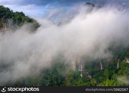 Fog and Rainbow in front of Thi Lo Su Waterfall, Beautiful waterfall in deep forest, Umphang National Park, Tak Province, Thailand.. Thi Lo Su Waterfall.